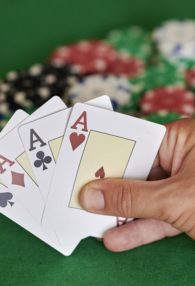 Hand with 4 aces in casino